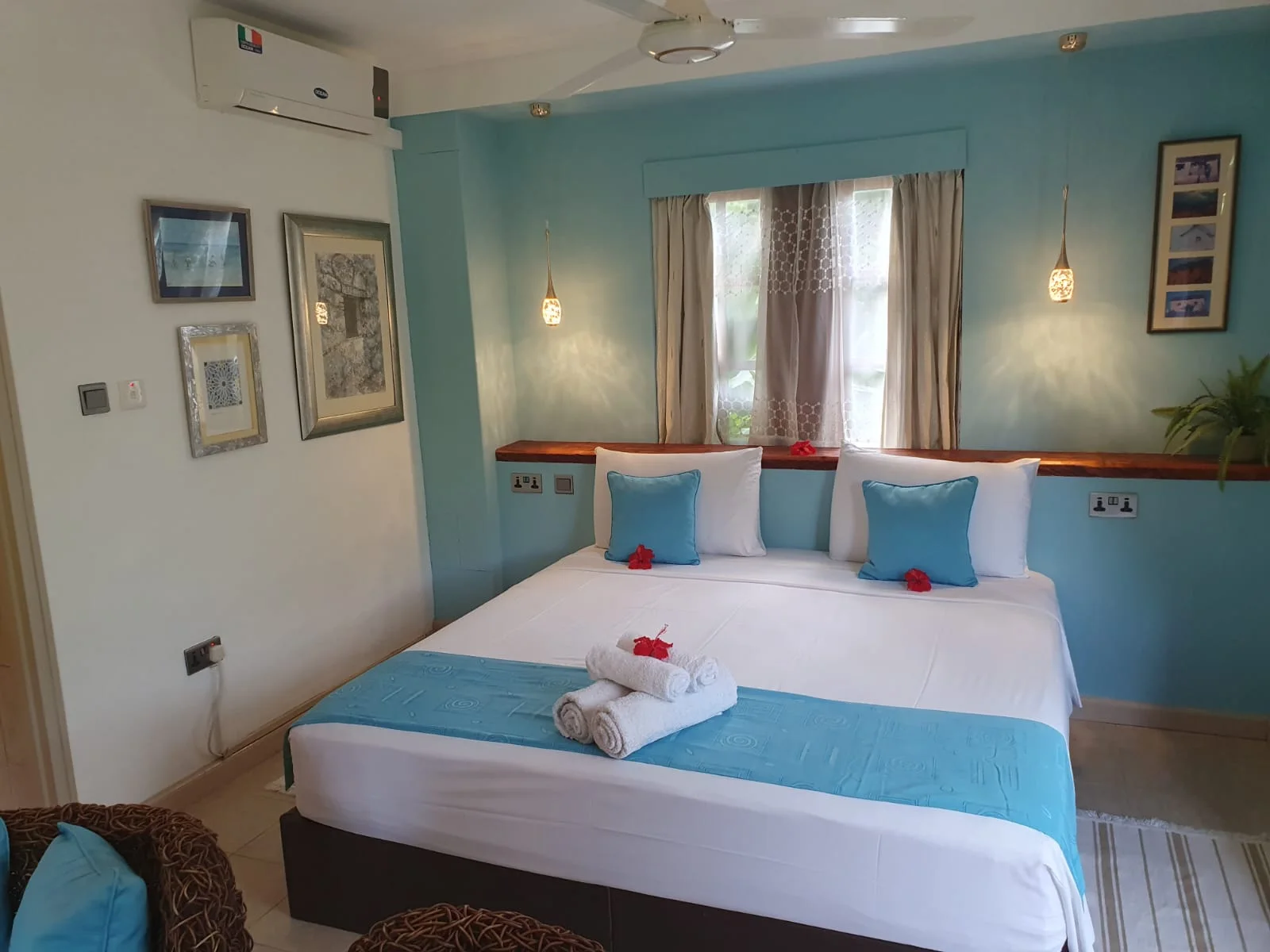 Bedroom with sliding doors opening to a private veranda with bamboo privacy screen — Garden Suite 1 at Maison Soleil, Anse Soleil, Seychelles