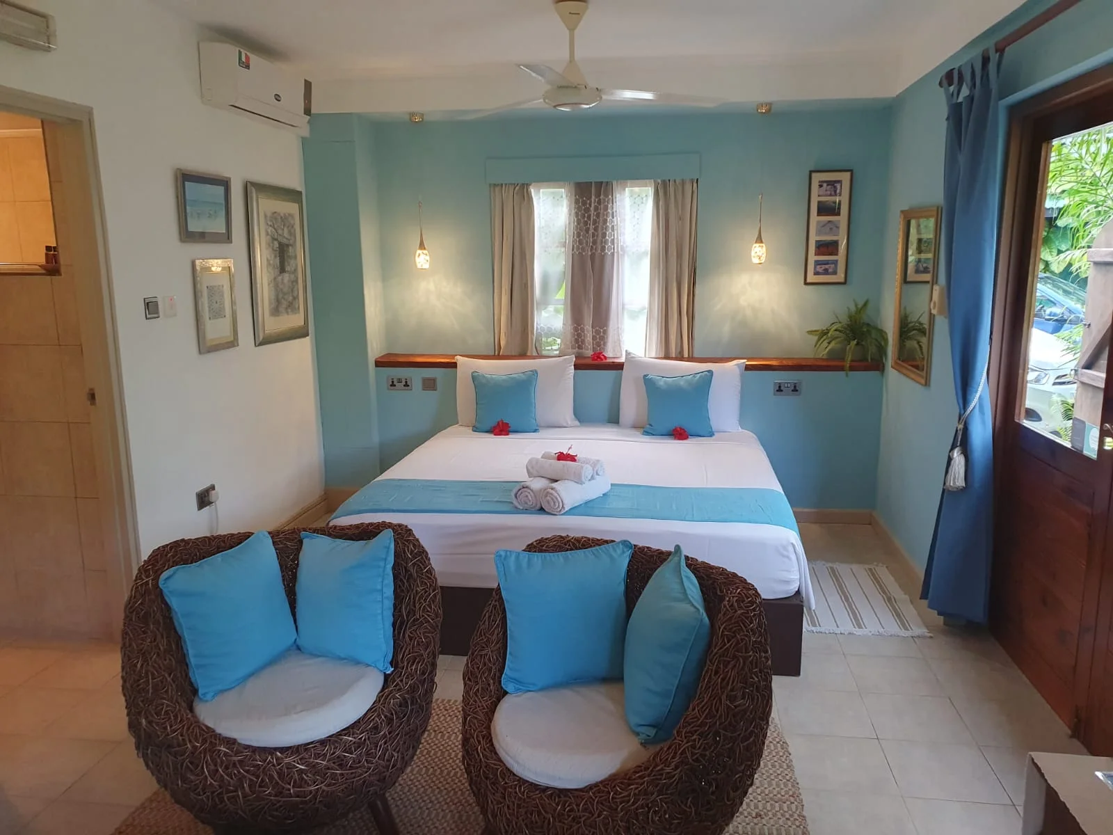Private terrace dining table overlooking the self-catering kitchenette and tropical garden — Garden Suite 1 at Maison Soleil, Anse Soleil, Seychelles