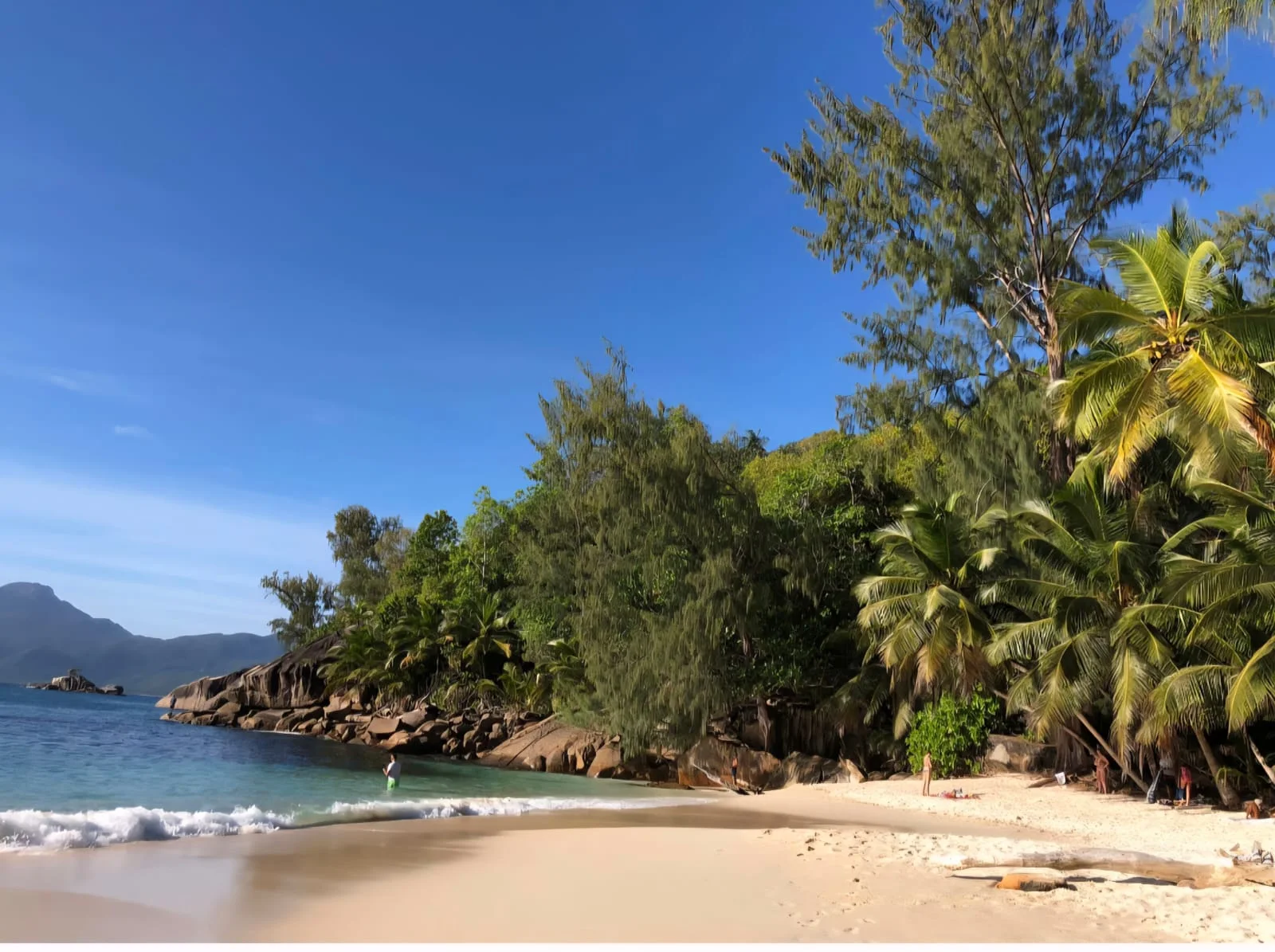 White sand beach with turquoise water, granite boulders and palm trees in south Mahé — near Maison Soleil at Maison Soleil, Anse Soleil, Seychelles (Petite Anse, Seychelles)