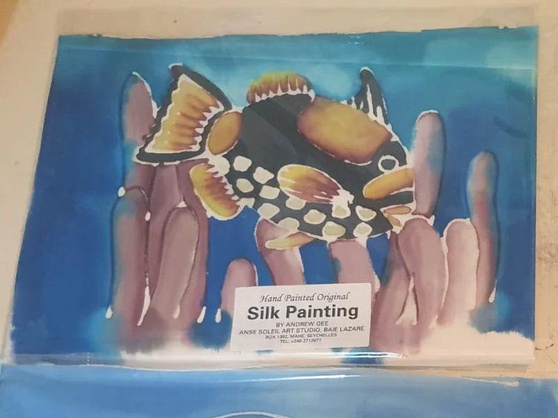 Hand-painted silk painting of a clown triggerfish on coral — original artwork at Anse Soleil Art Studio at Maison Soleil, Anse Soleil, Seychelles (Andrew Gee, Seychelles)
